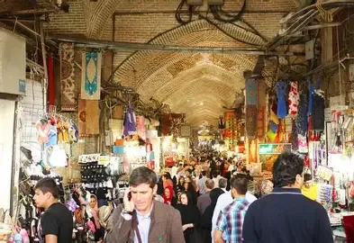 The vaulted, crowded aisle of a traditional bazaar